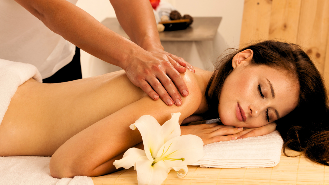 Beautiful girl getting a full body massage in a salon & spa